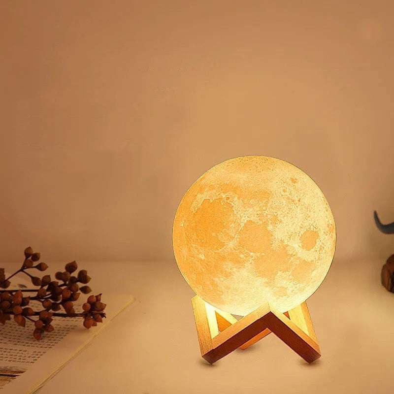 Warmly glowing 3d moon-shaped led night light with intricate details and wooden v-shaped stand featured in the best home and kitchen essentials for your 2026 upgrade.