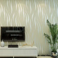 A sleek black flat-screen television mounted on a wall with beige and white woven wallpaper in women’s fashion interiors