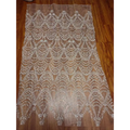 Sheer silver lace fabric with intricate silver wave style sequin bead lace in a scalloped pattern for wedding dresses