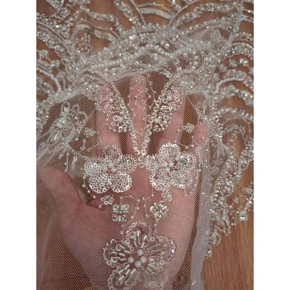 Wave style sequin bead lace fabric in sheer white with intricate silver sequin and pearl floral embroidery for wedding dress