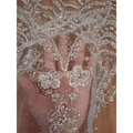 Wave style sequin bead lace fabric in sheer white with intricate silver floral embroidery for wedding dress design