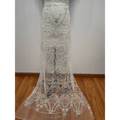 A sheer white lace wedding skirt with intricate silver wave style sequin bead lace in a cascading scalloped design