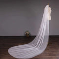 A white tulle wedding bride double-layer trimming veil with comb elegantly draped over a mannequin