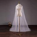 A delicate white tulle wedding bride double-layer trimming veil with comb elegantly draped over a mannequin