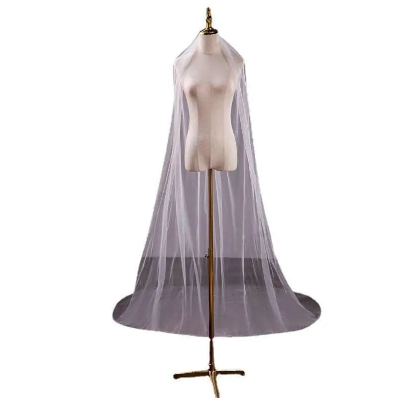 Wedding bride double-layer trimming veil in white tulle with a delicate sheer texture and long flowing train