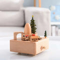 A light-colored wooden wedding rocking horse music box with rotating train and village for table decoration