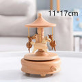 A light wood-colored wedding rocking horse wooden rotating music box with intricately carved horses and traditional roof design table decoration