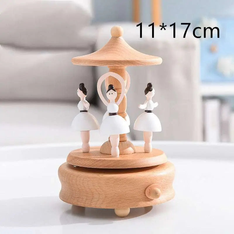 Wooden rotating music box with three white ballerina figurines under a canopy wedding rocking horse table decoration