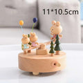 A charming wooden rotating music box with three painted bear figurines and colorful balloons for wedding rocking horse table decoration