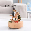 A charming wooden rotating music box with a wedding rocking horse couple and miniature red heart decorations