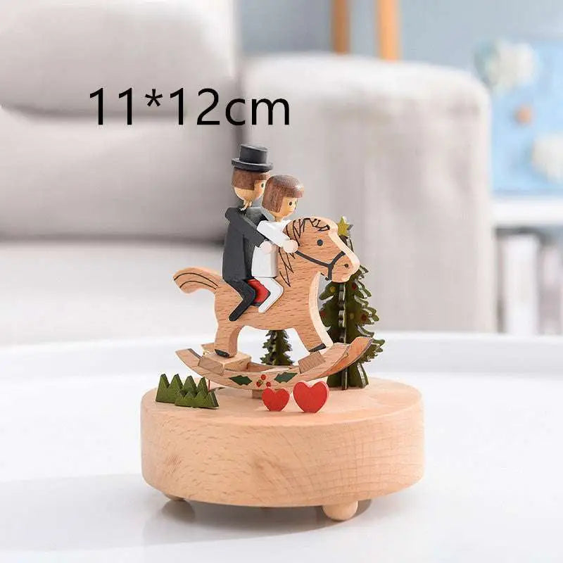 A charming wooden rotating music box with a wedding rocking horse couple and miniature red heart decorations