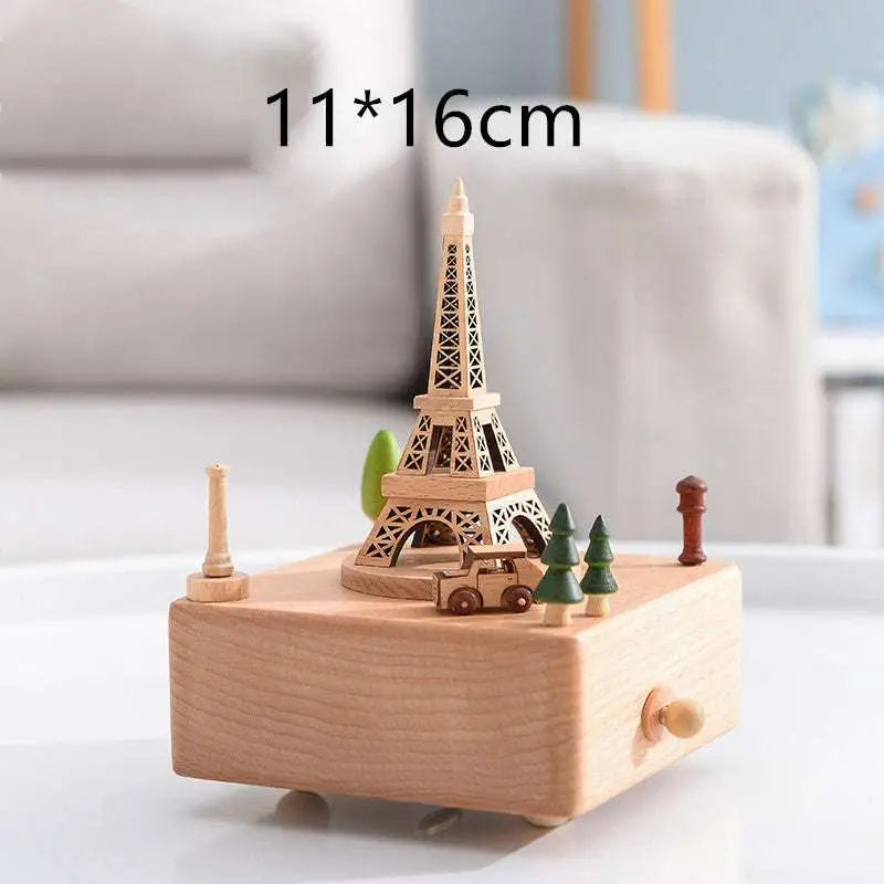 A light wood wedding rocking horse wooden rotating music box with an eiffel tower model table decoration
