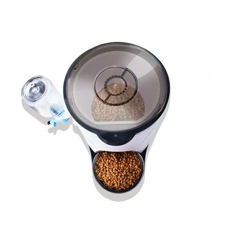 White and black pet automatic feeder with transparent top and water bottle attachment featuring battery power supply and feeding remote