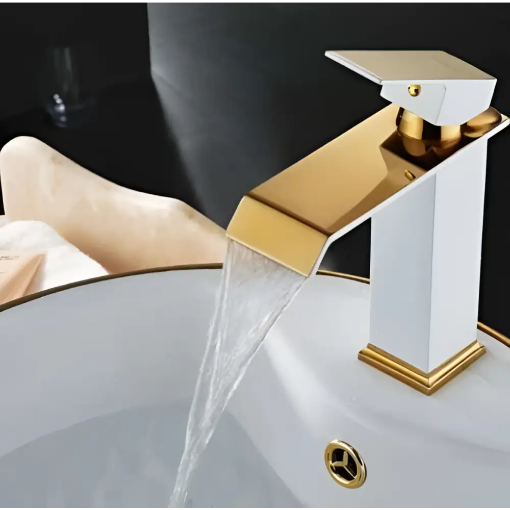 White and gold cold water waterfall basin faucet with sleek angular design and polished gold accents on white body