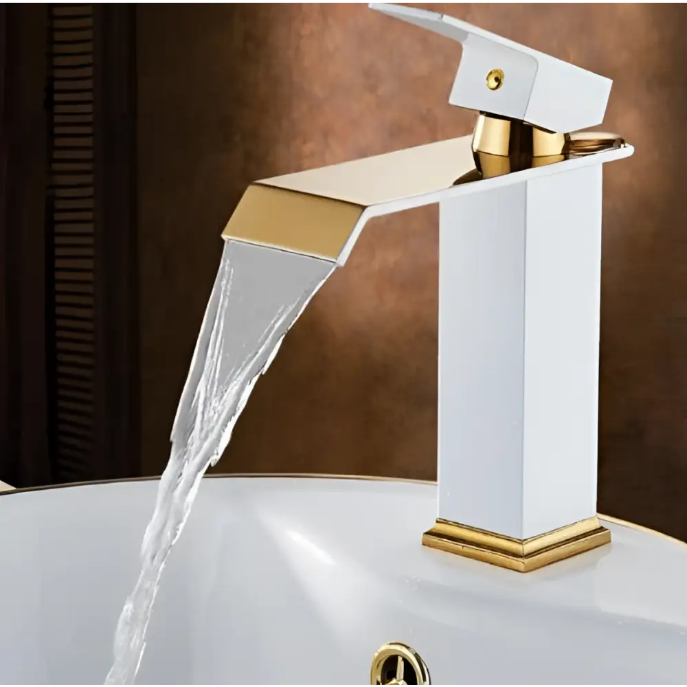 White and gold cold water waterfall basin faucet with sleek angular design and polished gold accents on white body