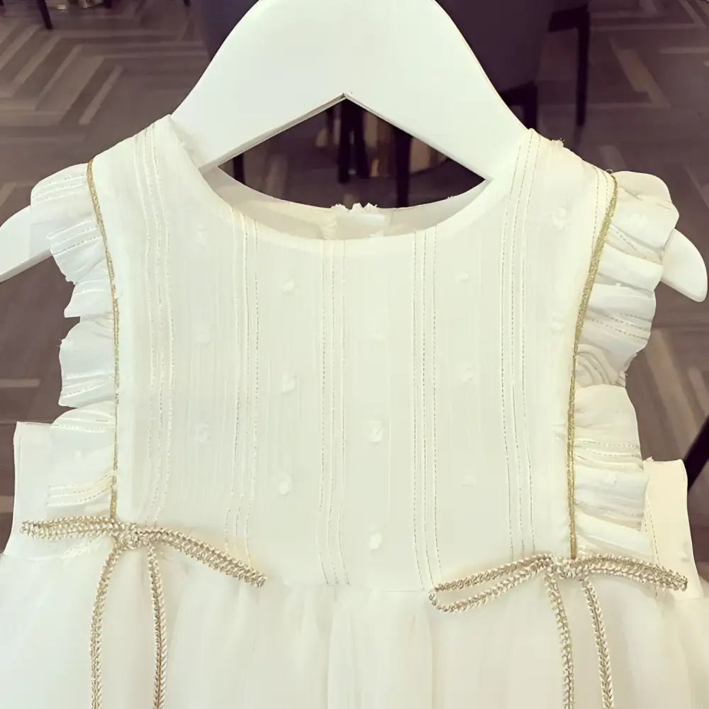 White beaded star baby gauze dress summer princess dress with ruffled shoulders and gold star charms at the waist