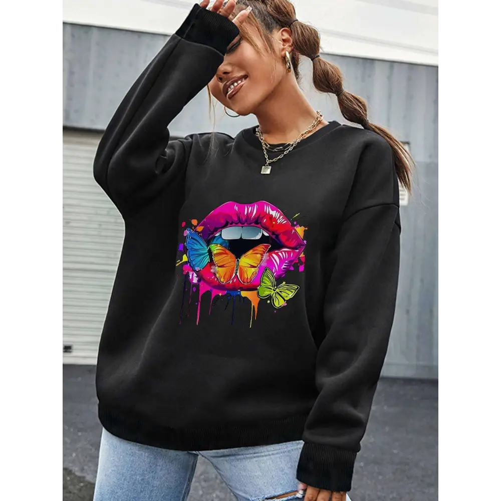 Black crew neck sweatshirt with white butterfly lips graphic featuring colorful lips, butterflies, and paint drips