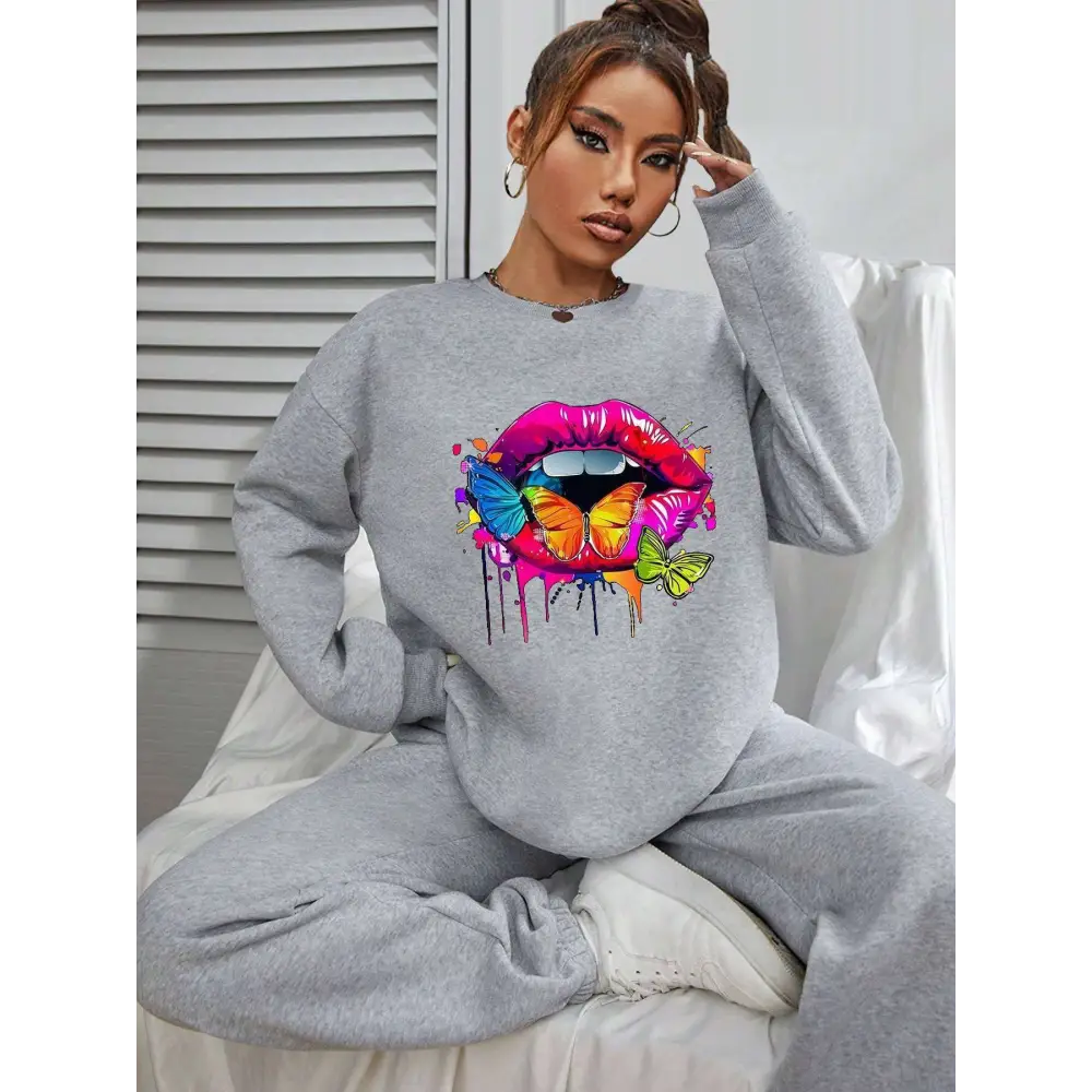 Gray crew neck sweatshirt featuring a vibrant white butterfly lips graphic with colorful lips and butterflies design