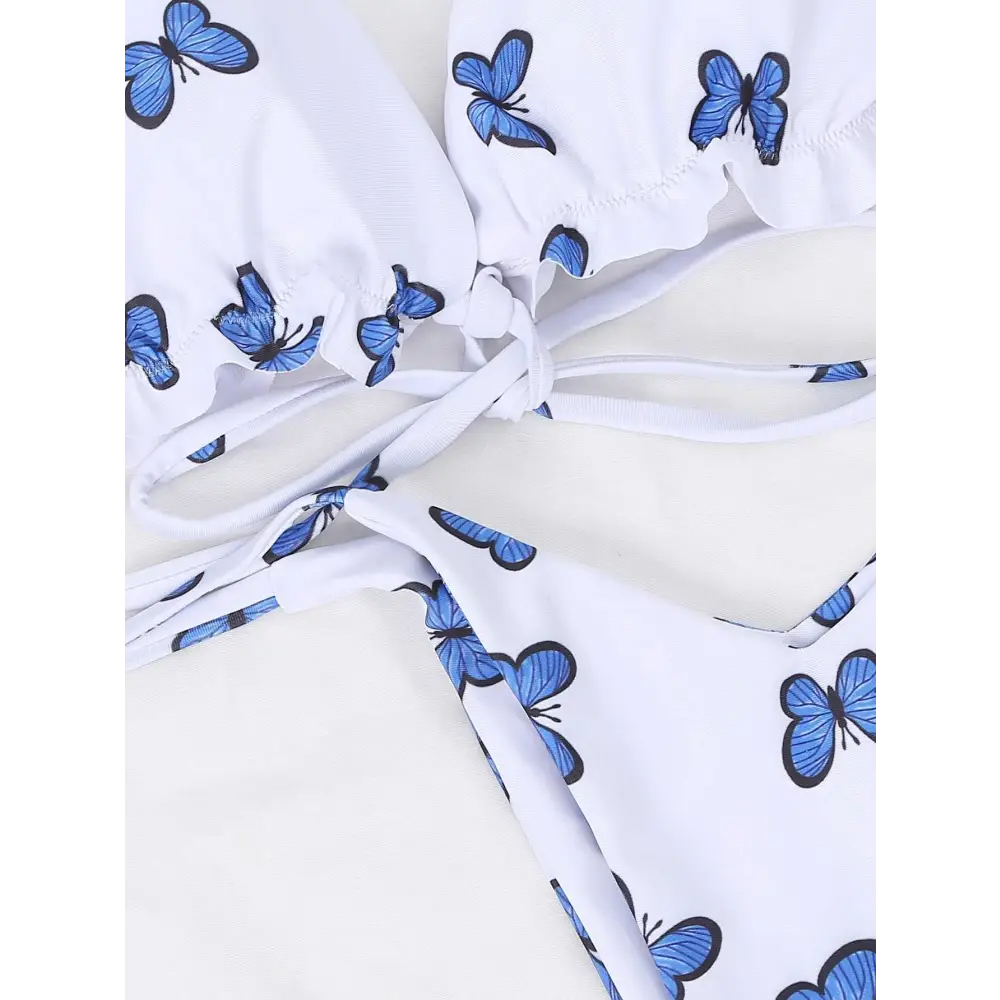 White butterfly print lace thong bikini top with blue butterfly prints and ruffled edges in a butterfly print swimsuit