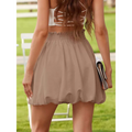 A flowing beige chiffon ruffled mini skirt with a gathered waistband and elastic waistband for casual wear