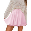 A soft pink ruffled mini skirt with a gathered waistband and flowing hem, ideal for casual graceful wear