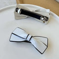 White ceramic camellia bow spring clip hairpin with black trim and silver clasp for female hair styling