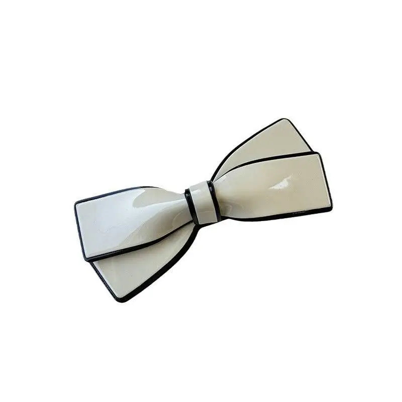 Cream-colored bow spring clip hairpin with black trim and glossy finish white ceramic camellia clip female hairpin