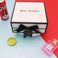 White clamshell gift box with black satin bow and best wishes text ideal for box lipstick packaging