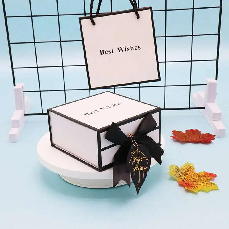 Elegant white clamshell gift box with black satin bow and gold-embossed best wishes for box lipstick packaging