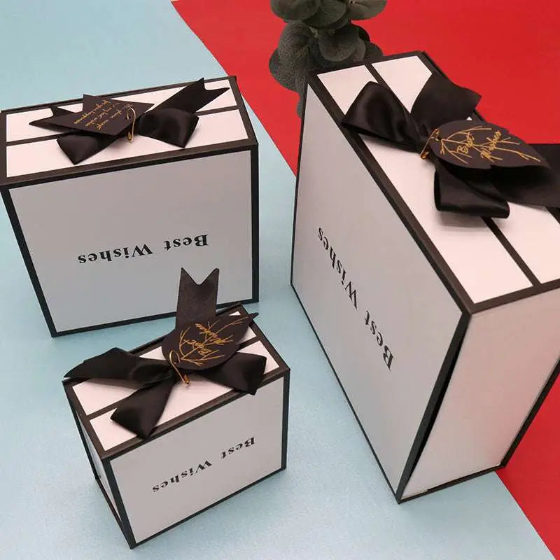 Elegant white clamshell gift box with black satin bow and gold-embossed best wishes for box lipstick packaging