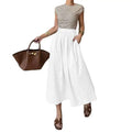 White cotton linen slimming large hem midi skirt with high waist and relaxed flowing pleated silhouette