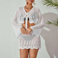 White crochet knitted beach bikini two-piece featuring bell sleeves and scalloped hem for stylish beachwear