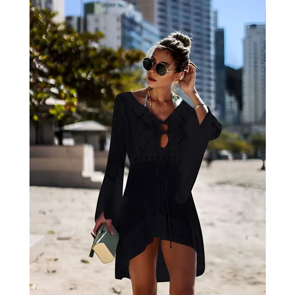 Black knitted long-sleeved dress with v-neck and side slit as a crochet women swimsuit cover-up dress