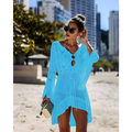A vibrant turquoise long-sleeved crochet women swimsuit cover-up dress with v-neck and asymmetrical hemline