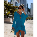 A vibrant turquoise long-sleeved crochet women swimsuit cover-up dress with v-neck and decorative cutouts