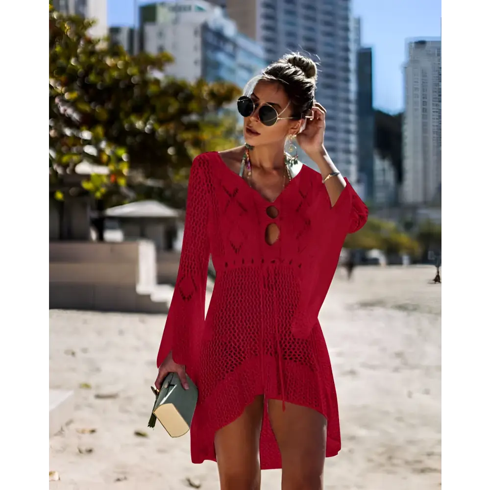 A vibrant red long-sleeved crochet women swimsuit cover-up dress with v-neckline and decorative buttons