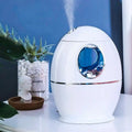 White egg aromatherapy humidifier usb rechargeable with glossy finish and blue-tinted circular window framed in silver