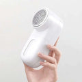 White electric lint and bulb remover with perforated circular head and smooth plastic body for luxury women’s fashion care