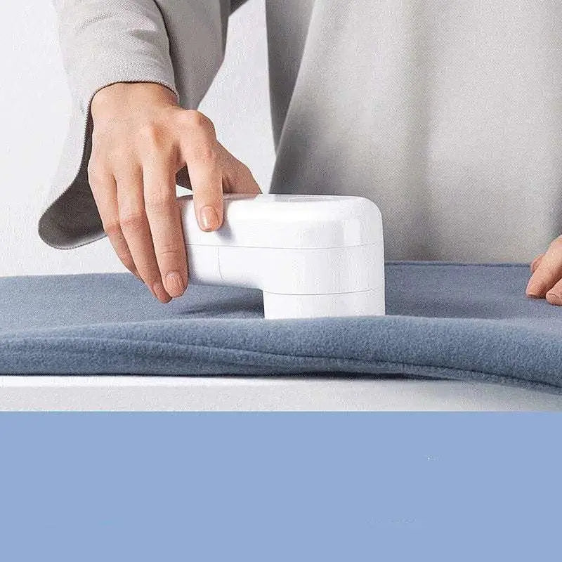 White electric lint and bulb remover with sleek compact design for easy use on luxury women’s fashion fabrics