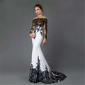 Elegant white embroidered lace maxi fishtail slim tail gown with intricate black lace detailing on bodice sleeves and hemline