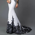 White embroidered lace maxi fishtail slim tail gown with intricate black lace detailing on sides sleeves and hemline