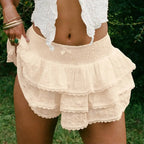 Cream-colored layered lace shorts with smocked waistband and floral embroidery in white eyelet lace bow decorative bud skirt style