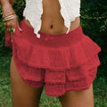 Red tiered lace shorts with smocked waistband and delicate eyelet lace bow detailing in decorative bud skirt style