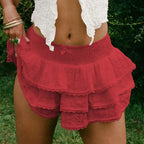 Red tiered lace shorts with smocked waistband and delicate eyelet lace bow detailing in decorative bud skirt style