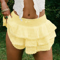 A vibrant yellow three-tiered decorative bud skirt in eyelet lace bow fabric with a gathered elastic waistband