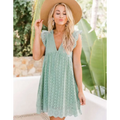 A light mint green summer sleeveless dress with delicate ruffled sleeves and scalloped hem in white eyelet pocket style