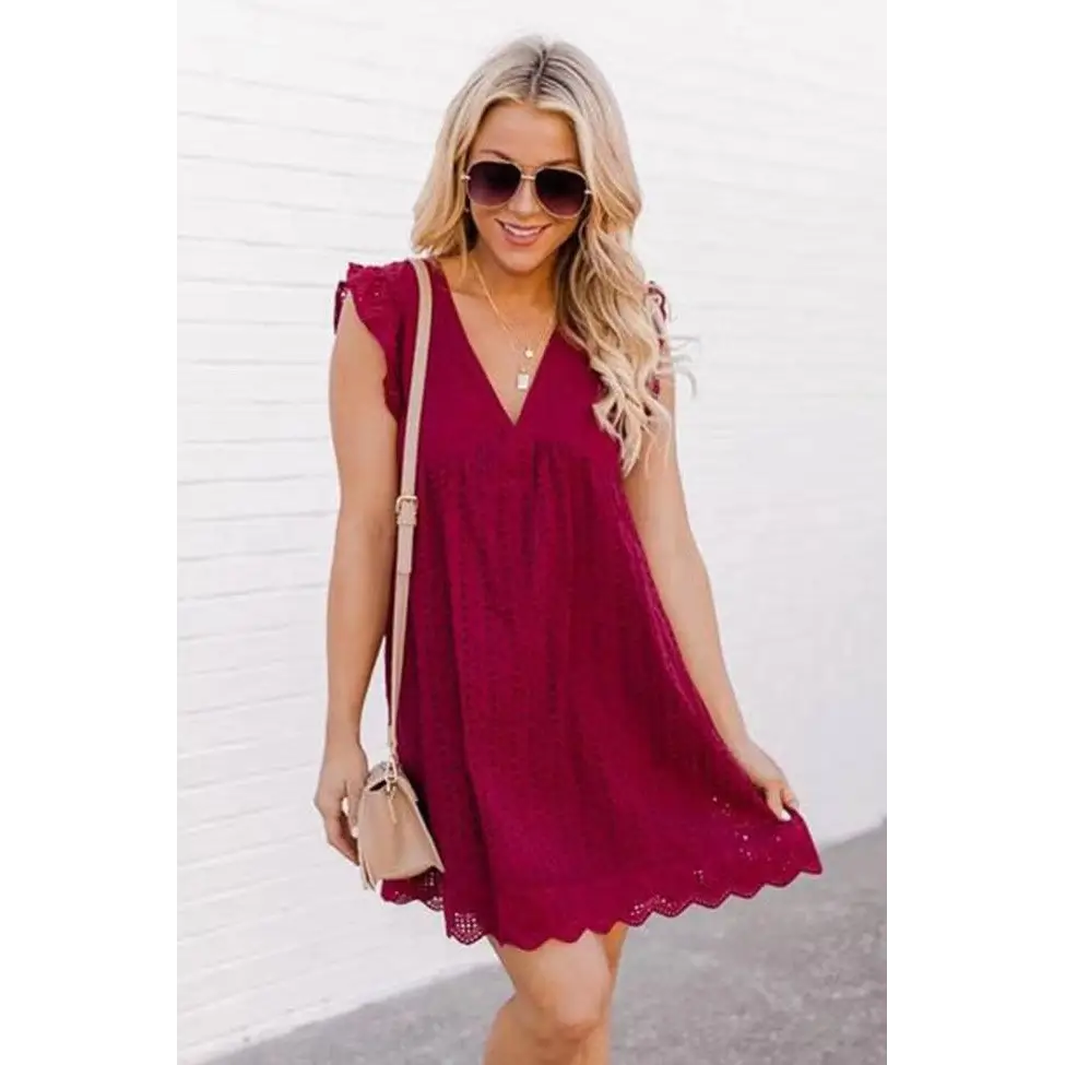 Deep red lace sleeveless dress with v-neckline and scalloped hem contrasting the white eyelet pocket summer sleeveless dress design