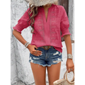 Pink embroidered blouse with short puff sleeve and v-neckline paired with white eyelet hollow hair ball accents