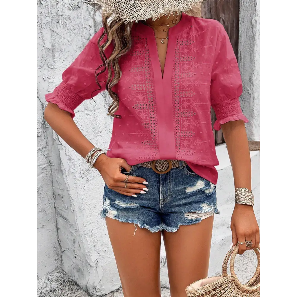 Pink embroidered blouse with short puff sleeve and v-neckline paired with white eyelet hollow hair ball accents