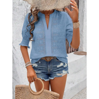 Light blue embroidered blouse with v-neck and three-quarter sleeves featuring puff sleeve and white eyelet details